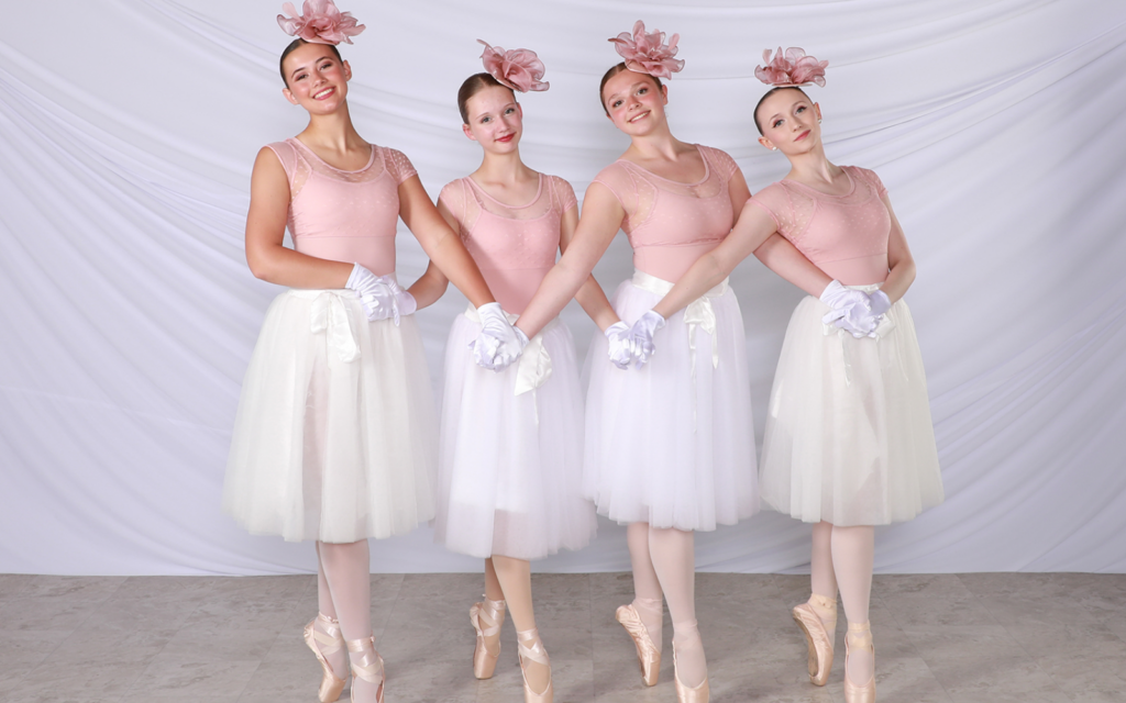 women holding hands on ballet